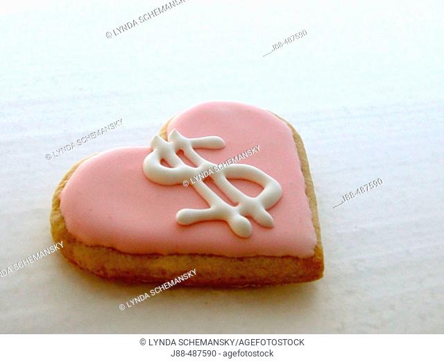 Heart shaped cookie with dollar symbol icing