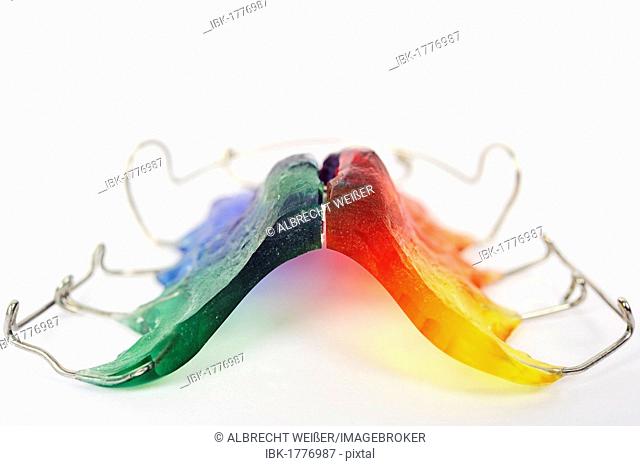Dental hygiene, braces with rainbow-coloured moulded plastic material