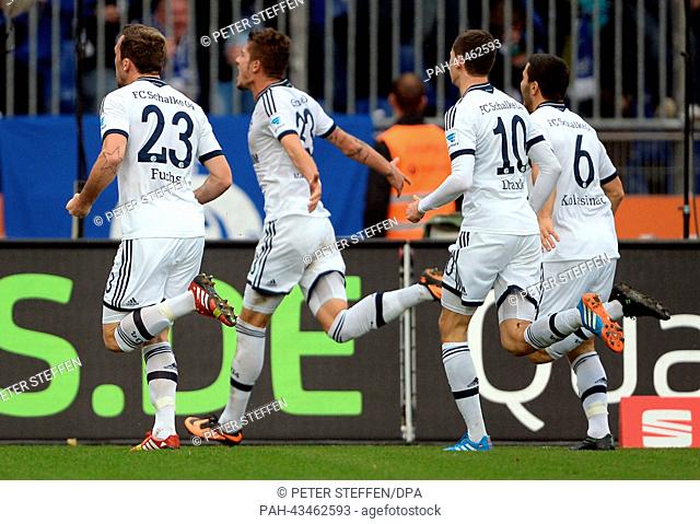 Schalke's Roman Neustaedter (2ND-L) cheers after he scored for 2:3 with Christian Fuchs (L), Julian Draxler (2ND-R) and Sead Kolasinac (R) during the Bundesliga...