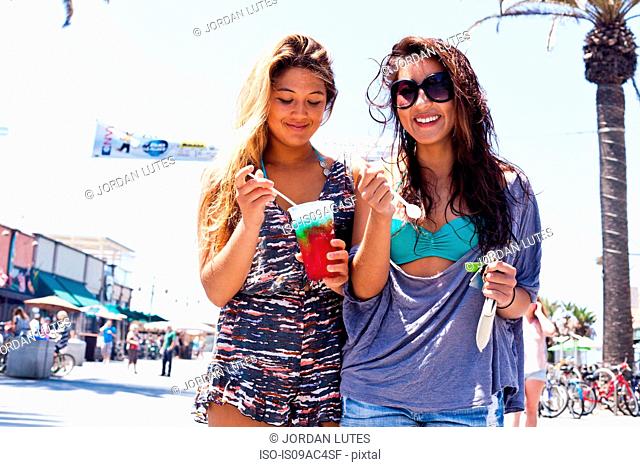 Female friends with iced drink, Hermosa Beach, California, USA