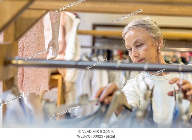 Senior woman shopping for clothes in a boutique