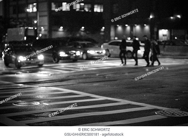 Group of People Crossing Street at Night, Brooklyn, New York, USA