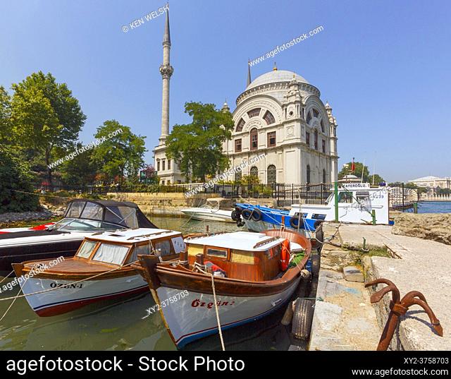 Istanbul, Turkey. The Dolmabahce Mosque on the Bosphorus seen over boats in harbour on Kabatas quay beside mosque