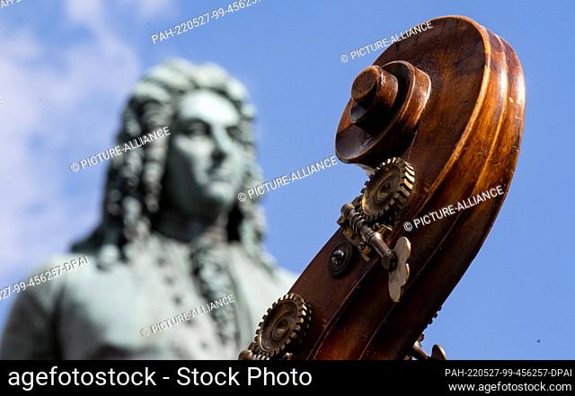 27 May 2022, Saxony-Anhalt, Halle (Saale): The scroll of a double bass is seen in front of the Handel monument in Halle/Saale during the opening of the 100th...