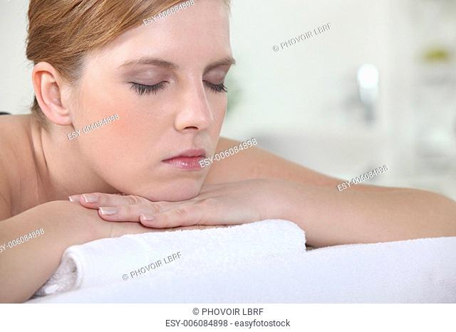 Woman with her eyes closed during a back massage