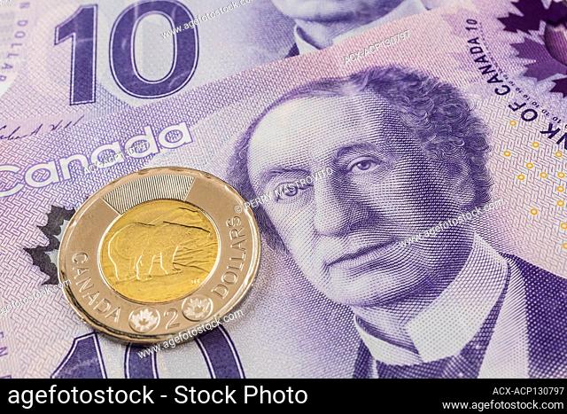Canadian two-dollar coin on top of Canadian ten-dollar bank notes with portrait of Sir John A. Macdonald, Studio Composition, Quebec, Canada