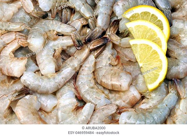 Many Raw Green King Size Shrimps With Slices Of Yellow Lemon, Top View, Close Up, Isolated