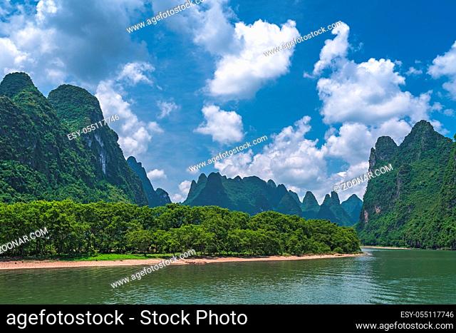 Panoramic view of the stunning karst mountain scenery on the riverbank of the magnificent Li river flowing between Guilin and Yangshuo towns, China