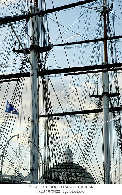 Close-up of Cutty Sark masts and rigging with Greenwich Foot Tunnel dome in the background, London, England