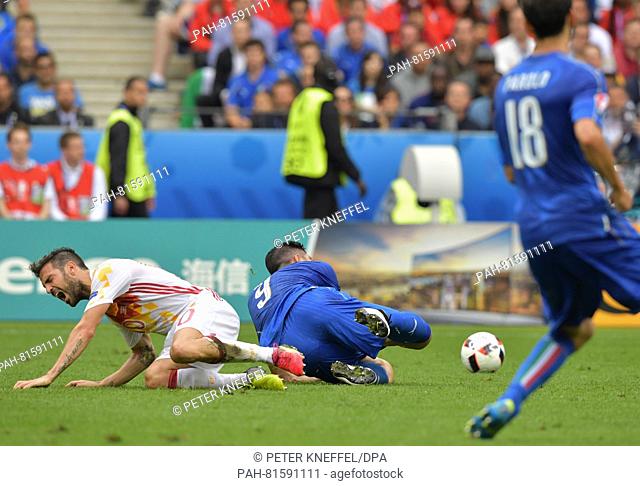 Graziano Pelle (R) of Italy and Cesc Fabregas of Spain vie for the ball during the UEFA EURO 2016 Round of 16 soccer match between Italy and Spain at Stade de...