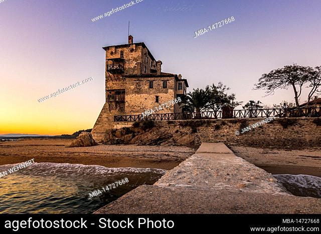 The famous Byzantine Tower of Prosphorion. The watchtower is located in Ouranoupoli Chalkidiki near Thessaloniki, Greece directly at the sea