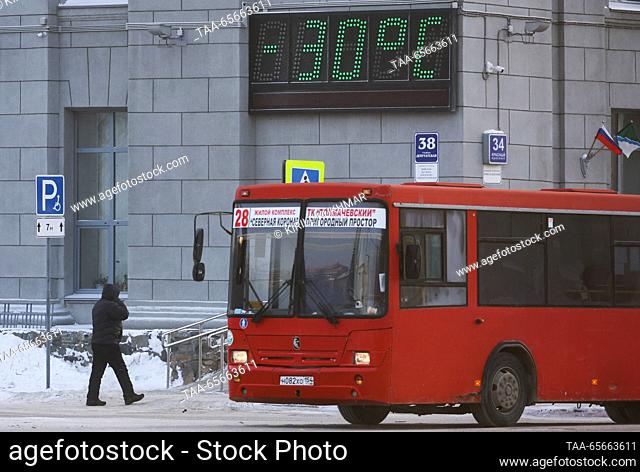 RUSSIA, NOVOSIBIRSK - DECEMBER 12, 2023: A bus passes a temperature display in Central District during severe frost in winter