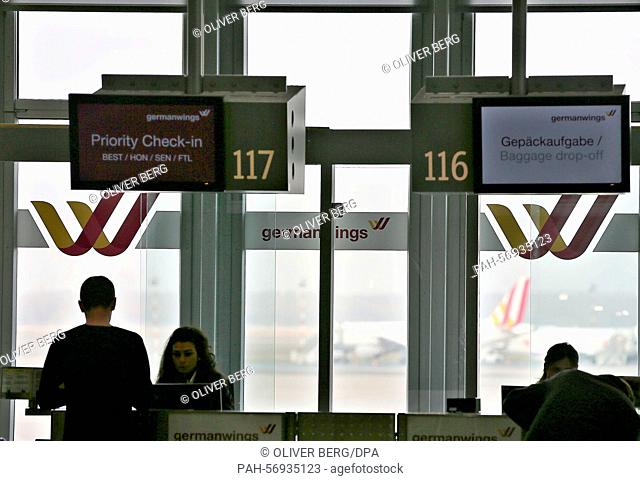 Passengers stand in front of a counter of the airline Germanwings at the airport in Duesseldorf, Germany, 24 March 2015. Germanwings Flight 4U 9525 from...