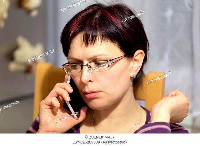 beautiful middle age tired woman without makeup call by phone and getting bad news