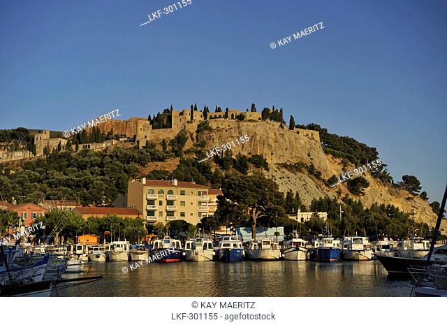 View at boats at harbour and fortress, Cassis, Cote d'Azur, Bouches-du-Rhone, Provence, France, Europe