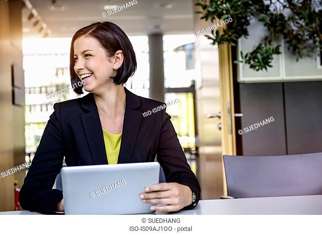 Young businesswoman with digital tablet in office