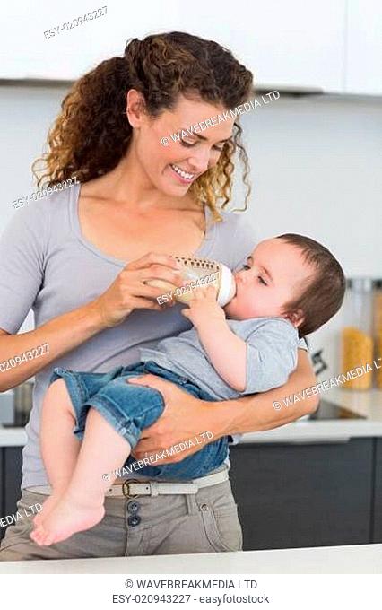 Woman feeding milk to baby