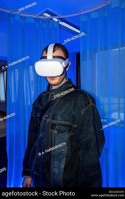 A young man wears a set of Augmented Reality glasses