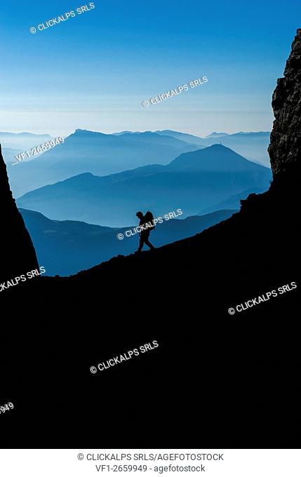 Brenta, Trentino, Italy. Early morning this hiker is on the Sentiero delle Bocchette Alte