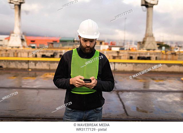 Dock worker using mobile phone