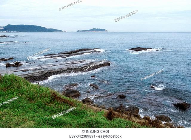 Yehliu coastal scenery with waves hitting the sedimentary rocks along the coast. Taken in New Taipei, Taiwan