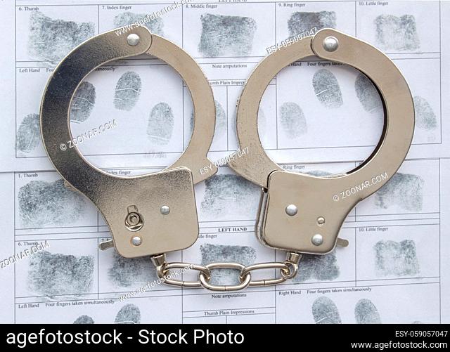 Top view of metal Handcuffs with generic hand prints