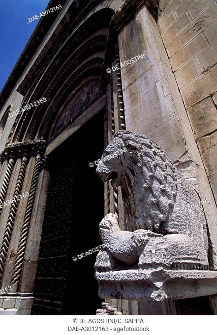 Lion flanking the main entrance to the Collegiate Church of St Maria (13th-14th century), Visso, Marche, Italy