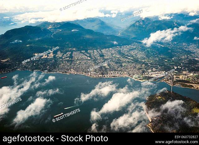 An aerial view of English Bay and West Vancouver from the window of a commuter airplane