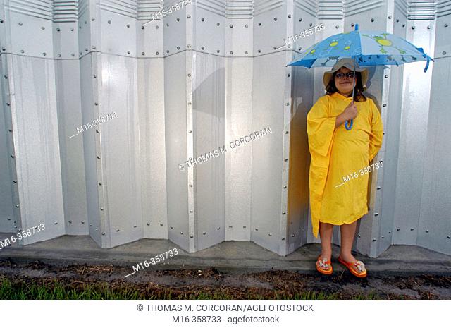 A little girl waits for the frequent rains of Central Florida. Summerfield. USA
