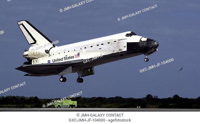 The Space Shuttle Endeavour's main landing gear is just about to touch down on Runway 15 at the Shuttle Landing Facility at the Kennedy Space Center (KSC)