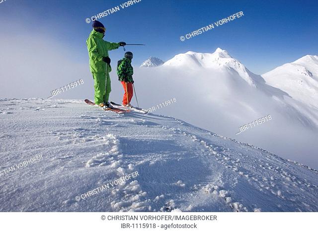 Freestyle skiers discussing the direction to the downhill snow run, Pass Thurn, Kitzbuehl Alps, North Tyrol, Austria, Europe