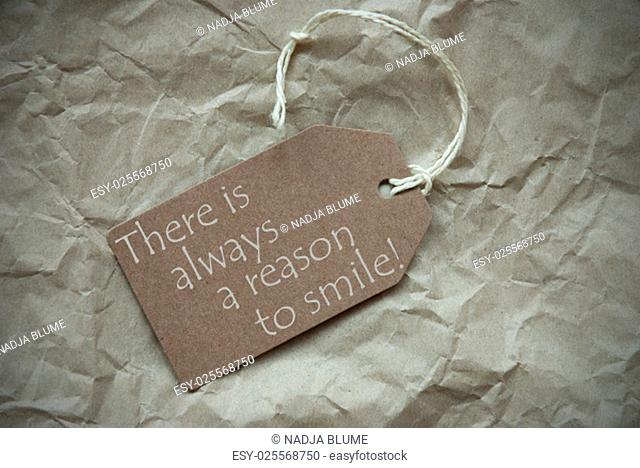 One Beige Label Or Tag With White Ribbon On Crumpled Paper Background. English Life Quote There Is Always A Reason To Smile Vintage Or Retro Style With Frame