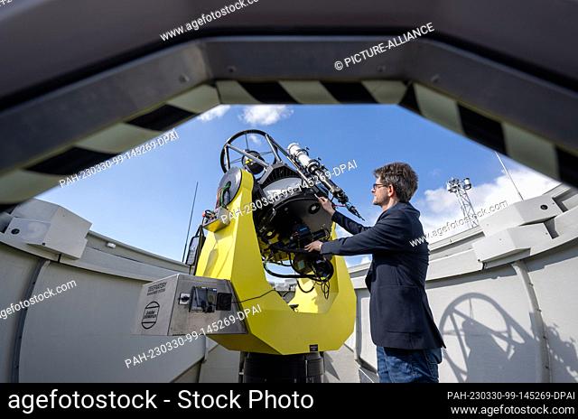 PRODUCTION - 27 March 2023, Saxony-Anhalt, Halle (Saale): Dirk Schlesier, director of the planetarium, stands at a telescope in the observatory on the roof of...