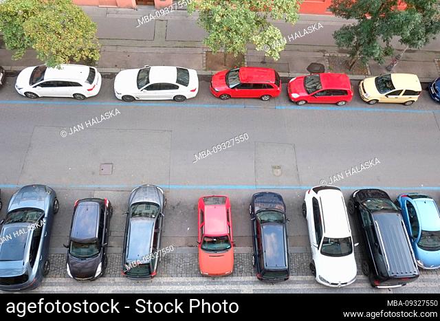 Aerial view of cars parallel parked and perpendicular parked on either side of Prague street. Czech Republic