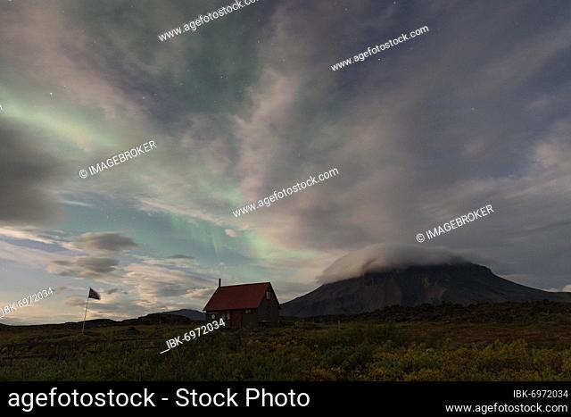 Northern lights (aurora borealis), Þorsteinsskáli hut, Herðubreiðarlindir oasis, Herðubreið or Herdubreid table volcano in the background, Icelandic highlands