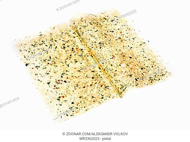 The sheet of culinary paper for roasting of chicken fillet is sprinkled spices- pepper, parsley, fennel, rosemary, basil and salt. Isolated with patch