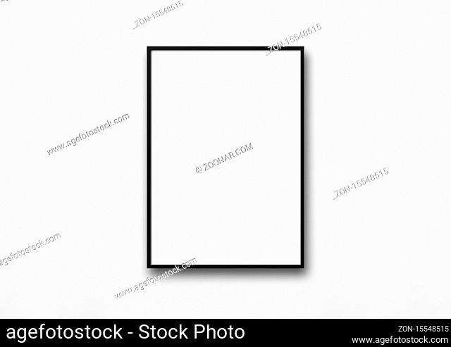 Black picture frame hanging on a white wall. Blank mockup template