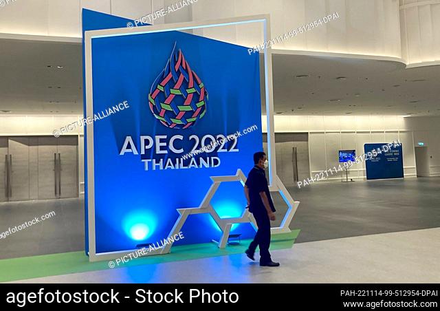 14 November 2022, Thailand, Bangkok: A man walks past the ""APEC 2022 Theiland"" lettering at the Queen Sirikit Convention Center