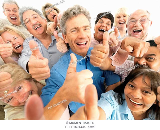 A group of people giving the thumbs up sign