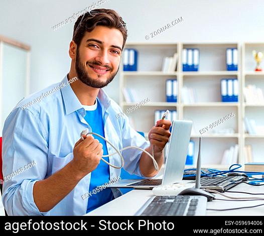 The it technician looking at it equipment