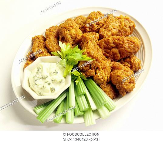 Buffalo chicken wings with celery and a blue cheese dip