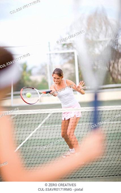 Serious girl playing tennis
