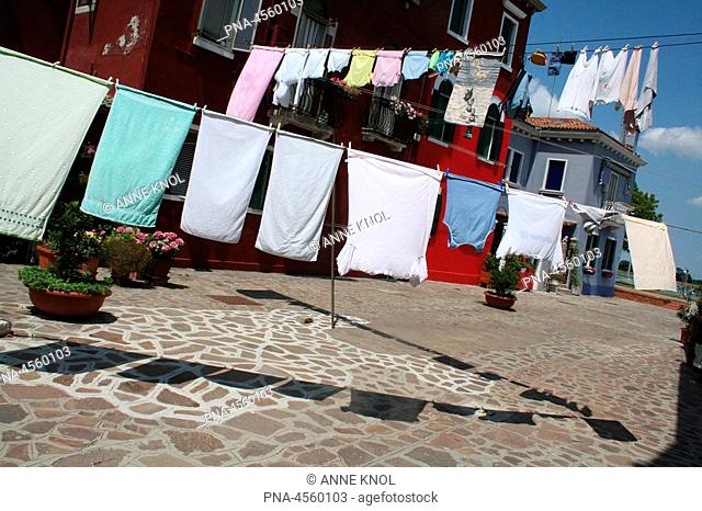 Street scene on Burano Island, Venice with laundry hung out to dry, Italy