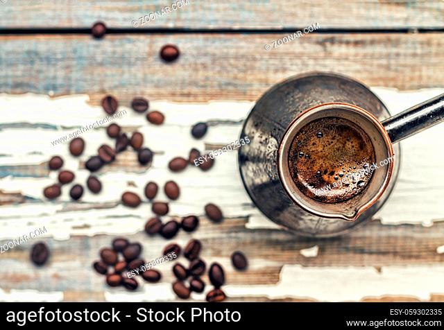 Coffee. Selective focus coffee in Turkish Cezve and grain on a white old windowsill, Closeup, top view, copy space