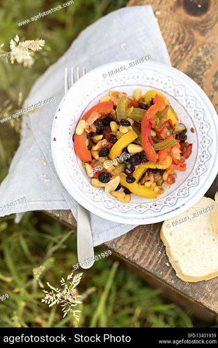 Pepper salad with pine nuts and currants