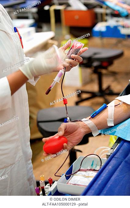 Person donating blood, cropped