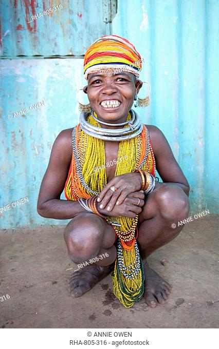 Bonda tribeswoman, smiling, wearing traditional bead costume with beaded cap, earrings and metal necklaces at weekly market, Rayagader, Orissa, India, Asia