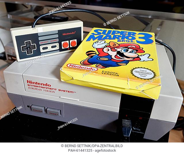 A 'Super Mario 3' game is on top of a 1980's NES games console, in Berlin, Germany, 8 September 2015. Photo: Bernd Settnik/dpa | usage worldwide