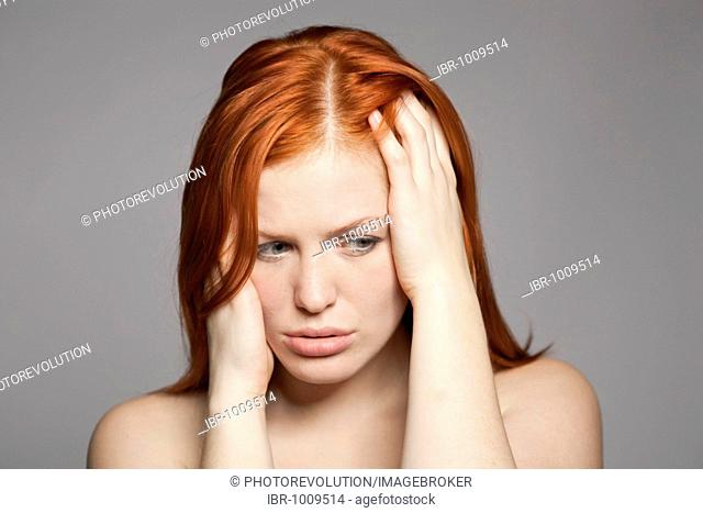 Young, red-haired woman, distressed, sad