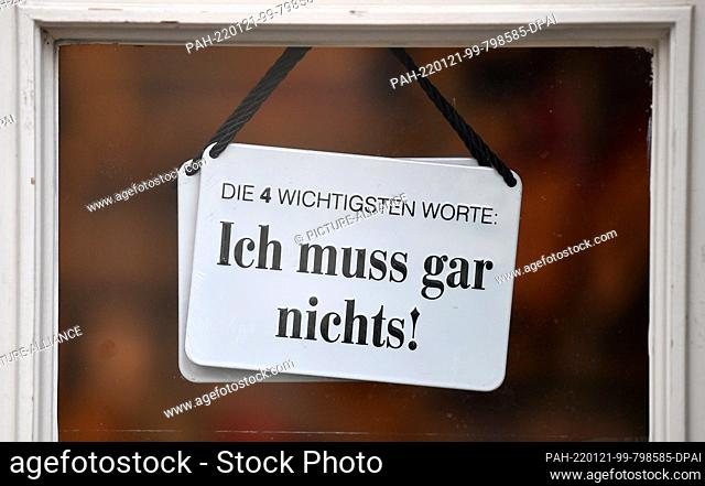 21 January 2022, Thuringia, Erfurt: ""The four most important words. I don't have to do anything!"" is written on the sign in the door of a downtown store
